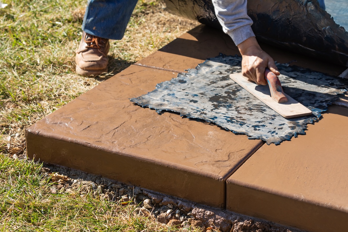 Concrete worker stamping concrete